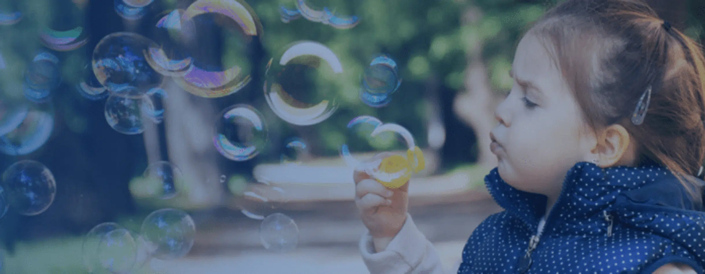 Child Blowing Bubbles at Compass - Nebraska a Bloomerang customer