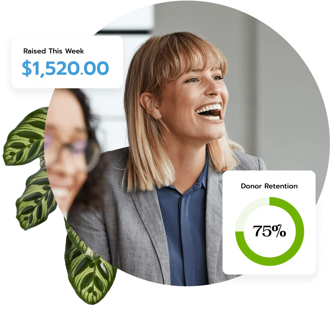 A woman wearing a grey blazer laughs with her coworkers after hearing a joke from a presentation on their organization's impact with their donors.