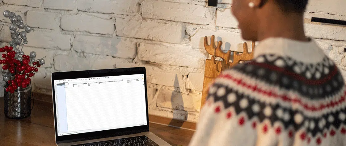 woman working on excel sheet at computer