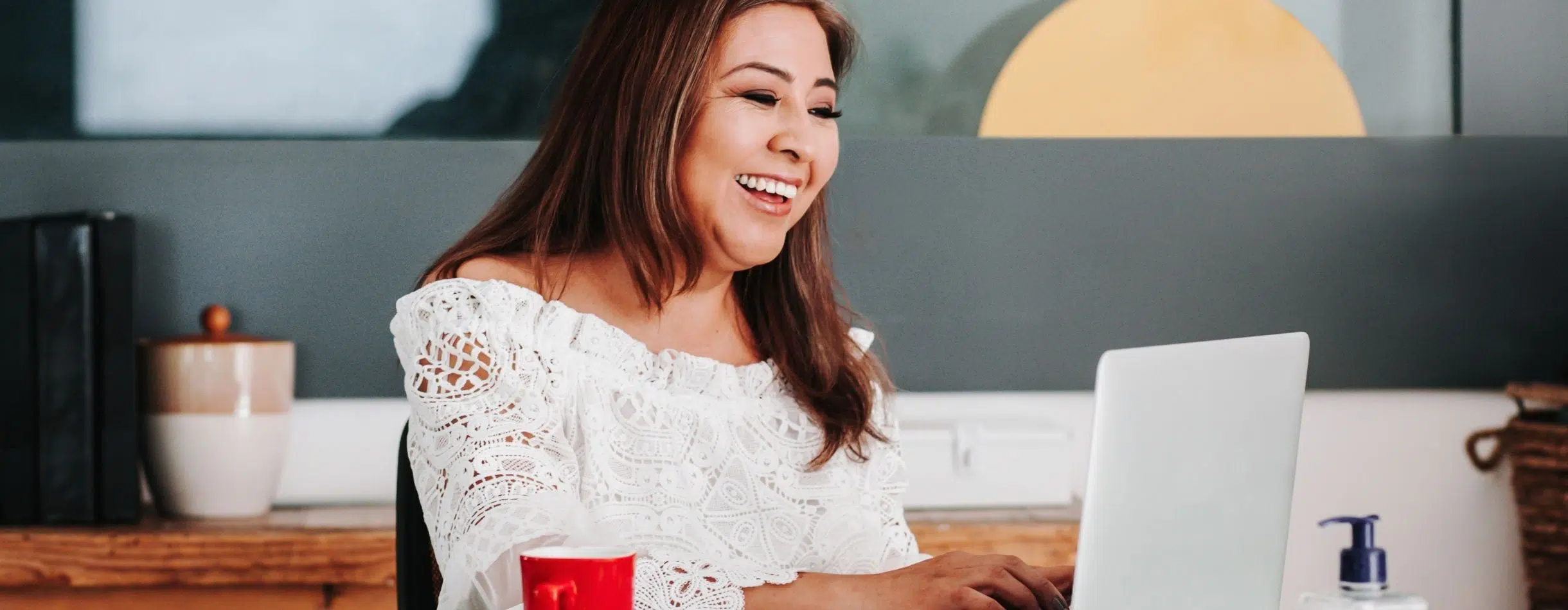 woman smiling at her computer