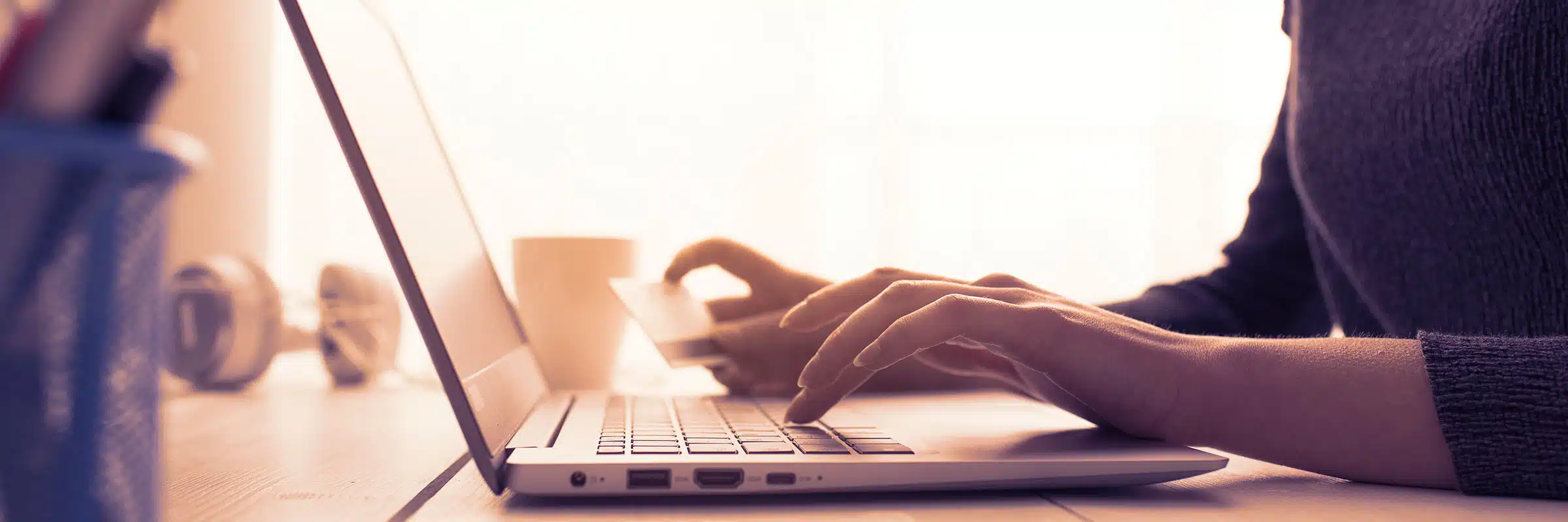 Someone making an online donation using a credit card and laptop