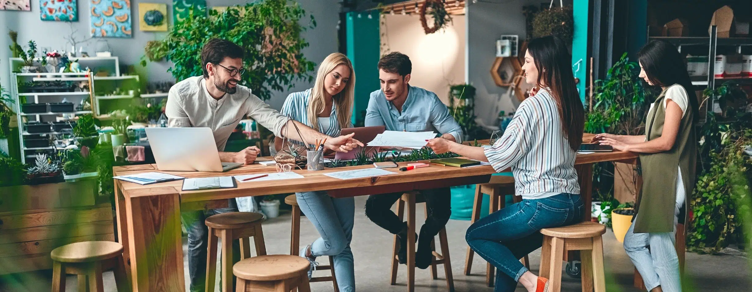 A group actively collaborates across a long table.